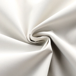 Detail shot of beige outdoor jacket fabric showing waterproof texture and weave