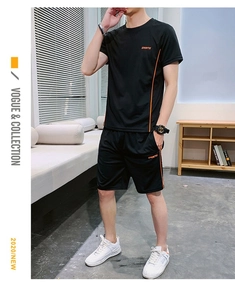 Vue détaillée de l'ensemble de sport noir avec bandes orange et lettrage du logo