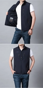Detail of dark blue fishing vest featuring breathable mesh lining and zippered inner pocket