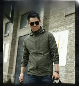 Detail of olive green hooded jacket featuring zip pockets and elastic cuffs for outdoors