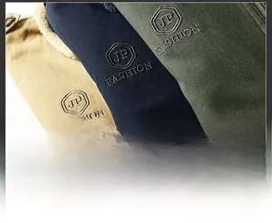 Detail shot of heavy-duty cotton jacket fabrics in khaki, navy blue, and olive green colors