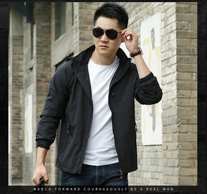 Detail of men's black outdoor hooded jacket with high-quality zipper and elastic cuffs