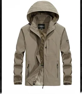 Detailed close-up of khaki outdoor hooded jacket showing zipper and arm badge detail