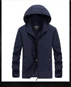 Detail of dark blue waterproof jacket showing front zipper and functional pockets