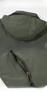 Detail of outdoor jacket showing hooded collar, mesh lining, and secure zipper pockets