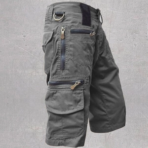 Close-up detail of cargo shorts showing utility pockets and durable metal D-ring buckle
