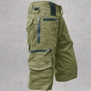 Detail view of military green cargo shorts featuring tactical multi-pocket design and D-ring