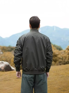Olive green MA-1 flight bomber jacket featuring ribbed collar and tactical ruched sleeve detail