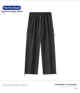 Detail of black summer techwear parachute pants with functional cargo pockets and drawstring