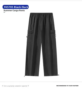 Rear view of black technical cargo pants featuring elastic waist and utility flap pockets