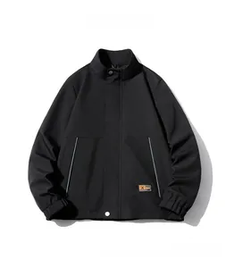 Close-up of black worker jacket with elastic cuffs and orange accent label detail