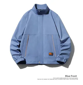 Detail of blue stand collar jacket with side pockets and branded patch on the hem