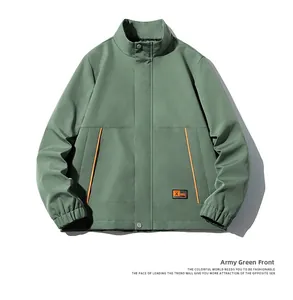 Detail of army green jacket featuring snap button closure and orange pocket stitching