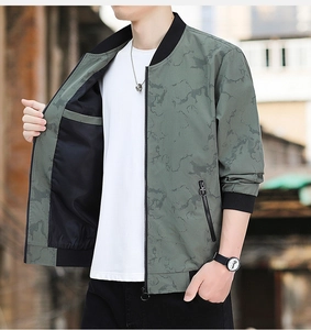 Detail of green bomber jacket featuring a ribbed collar and marble camouflage pattern