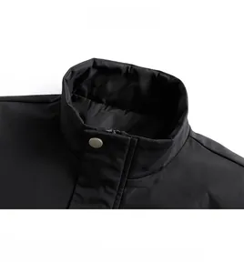 Close-up of black jacket collar featuring a silver metal snap button and hidden zipper