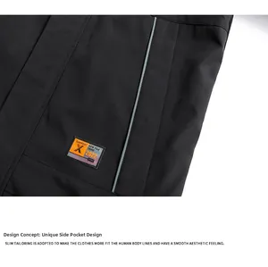 Detail of windproof black jacket featuring zipper side pocket and orange logo patch