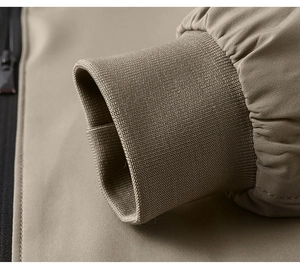 Detail shot of khaki jacket featuring elastic ribbed cuffs and high-density woven fabric