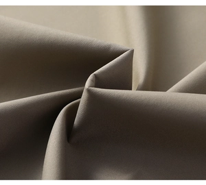 Close-up of premium khaki twill fabric texture on a men's business casual jacket