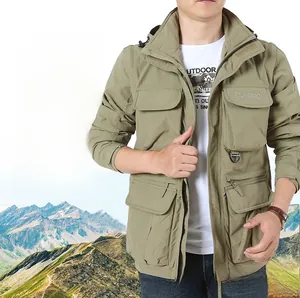 Detail of khaki outdoor jacket showing tactical pockets and durable fabric texture