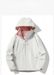 Flat lay of a grey windproof jacket with pink accents showing zippers and hood details