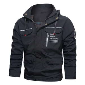 Close-up of black outdoor hooded jacket with multiple flap pockets and contrast lining