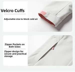 Detail of adjustable velcro cuffs and secure zip pockets on gray outdoor jacket