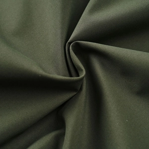 Detailed macro view of olive green high-density synthetic fabric with fine woven texture
