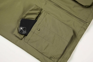 Detail of army green utility vest featuring a large cargo pocket with metal snap button