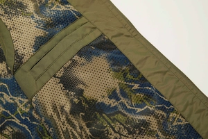Detail of olive green fishing vest featuring breathable mesh lining and forest camo print