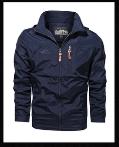 Detail of navy windbreaker chest zipper pocket with Outdoor printed text and standing collar