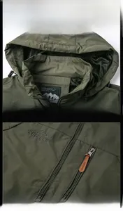Detail view of army green outdoor jacket featuring hood mesh lining and embroidered chest logo