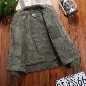 Men's olive winter jacket with thick sherpa lining on a rustic wood background
