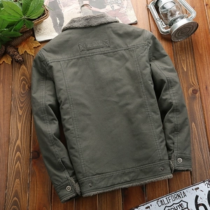 Army green fleece-lined men's winter jacket with fashion patch on rustic wooden backdrop