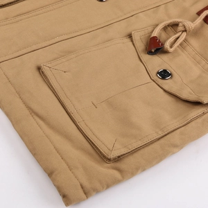 Close-up of khaki winter jacket featuring flap pocket, metal button and drawstring