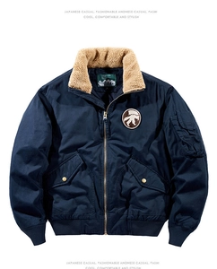 Detail of navy blue pilot jacket showing wool collar and mammoth embroidered patch