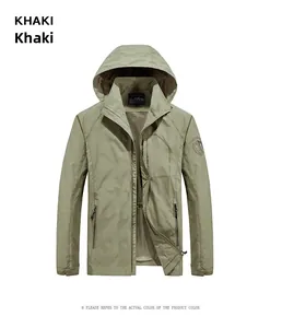 Detail of khaki outdoor hooded jacket showing waterproof zippers and velcro cuffs