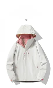 Detail of warm white waterproof outdoor jacket with coral pink zipper and accents