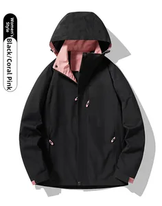 Close-up of women's black outdoor jacket with coral pink lining and adjustable hood