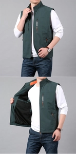 Detail of dark green outdoor vest with stand collar and orange contrast lining