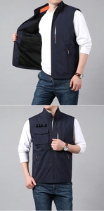 Detail view of functional navy blue vest with orange lining and multiple pockets
