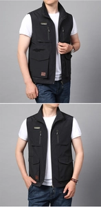Detailed view of black multi-pocket outdoor vest featuring Adventurous mountain patches
