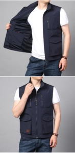 Detail view of men's navy blue fishing vest featuring mesh lining and multiple cargo pockets