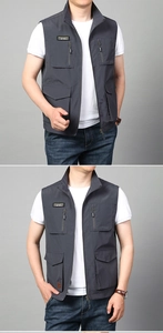Close-up of dark grey men's multi-pocket tactical vest with zipper and standing collar