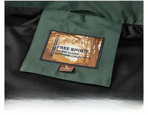 Macro detail of men's outdoor vest featuring dark green fabric and breathable mesh lining