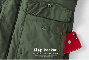 Detail view of cargo jacket flap pocket and side pocket holding a smartphone for scale