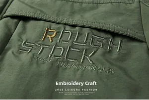 Detailed close-up showing high-quality embroidery craft on washed military green cotton jacket