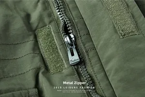 Detail of high-quality metal zipper and velcro closure on vintage green cotton jacket