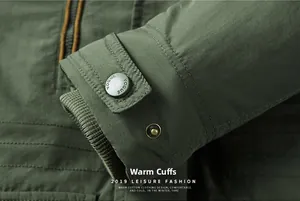 Detail of warm ribbed cuffs on an olive green washed jacket with adjustable metal buttons