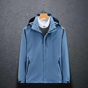 Detail of blue waterproof hood and zipper on a lightweight outdoor windbreaker jacket