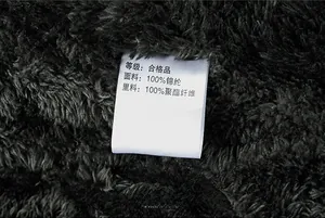 Detail of fleece lining and care label showing 100% nylon fabric for the winter jacket